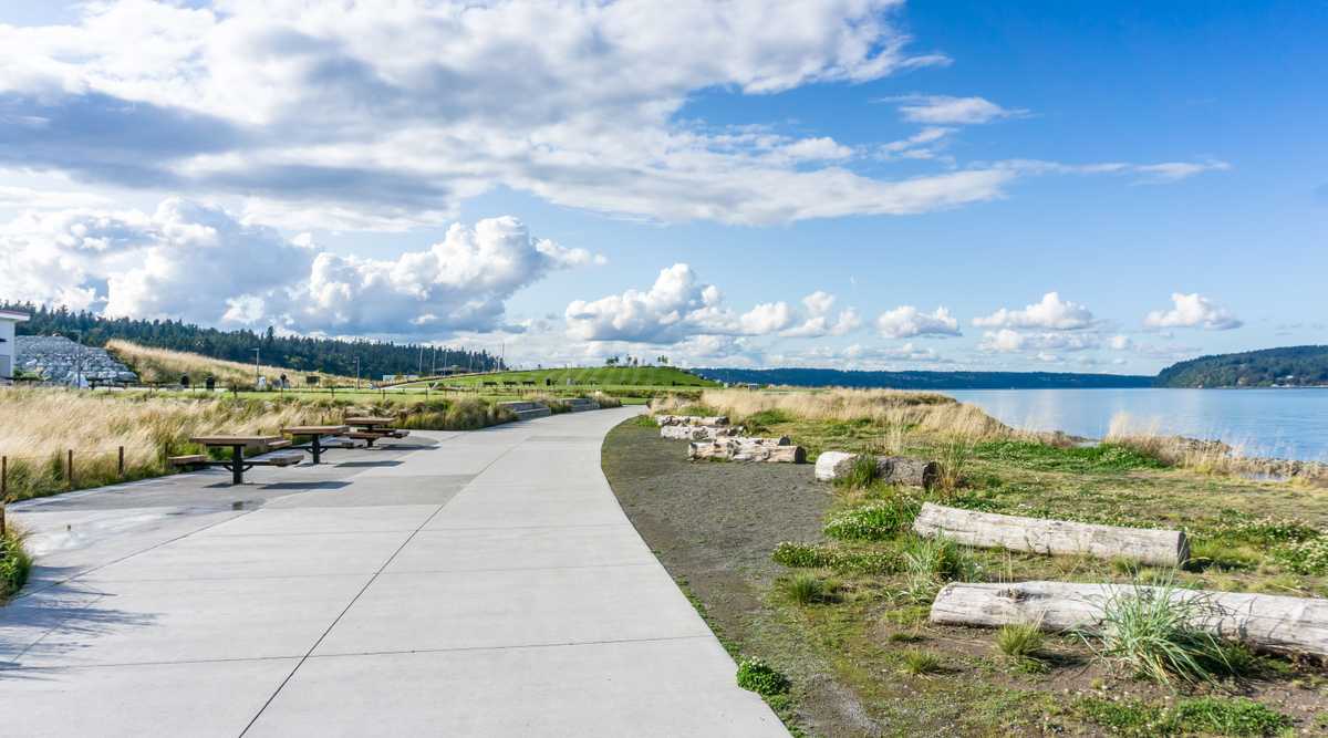 Billowing clouds hover over the Puget Sound and Dune Peninsula Park in Tacoma, Washington.